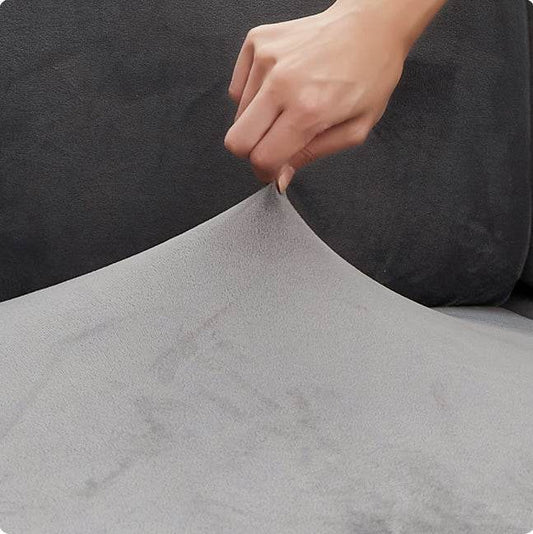 Close-up of hand pinching plush velvet fabric, showing the stretch and softness of premium sofa covers—ideal as couch covers, recliner covers, or chair covers.