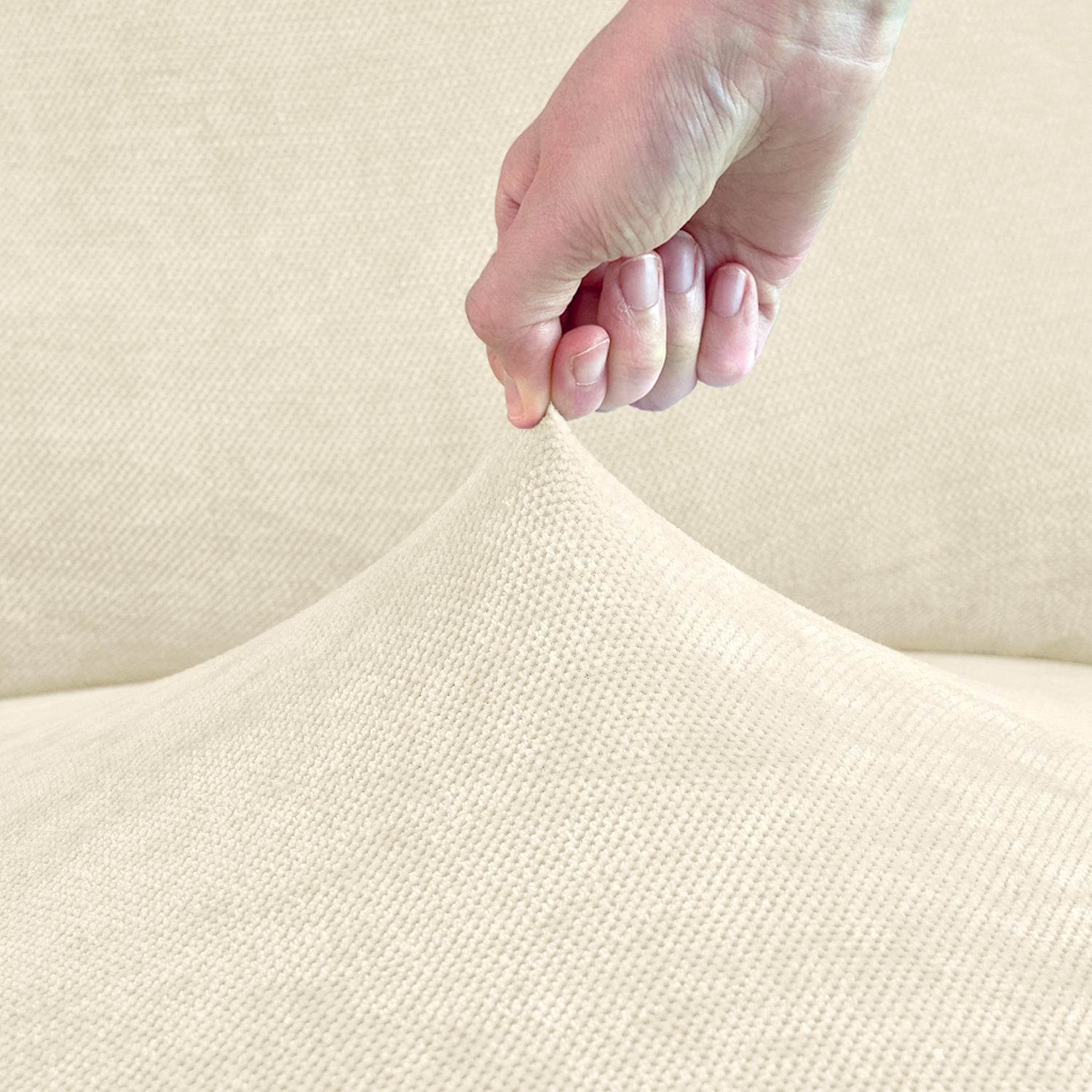 Close-up of a hand touching a soft fabric surface, highlighting the plush texture and quality of the Cozee TouchSoft Armrest Cover.